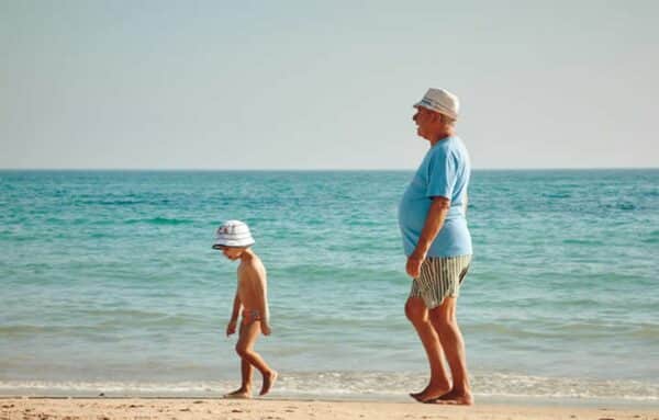 grandfather with grandson at the beach